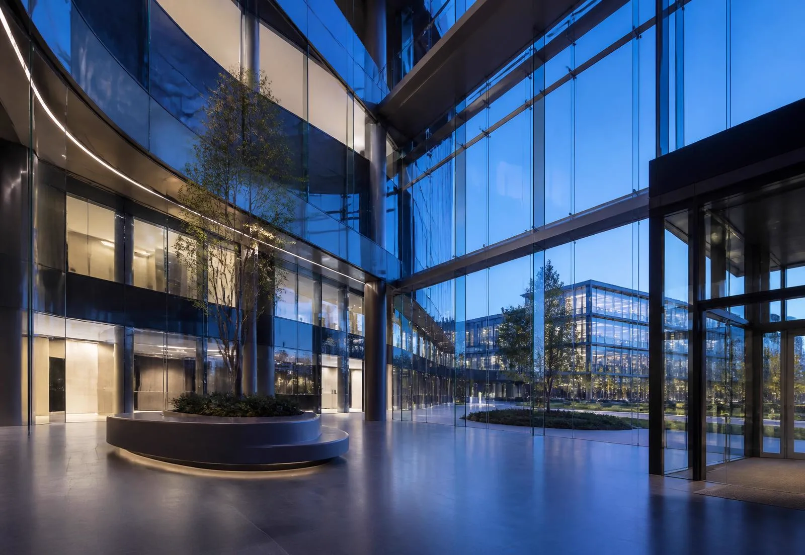 Modern technology campus lobby with glass architecture at dusk